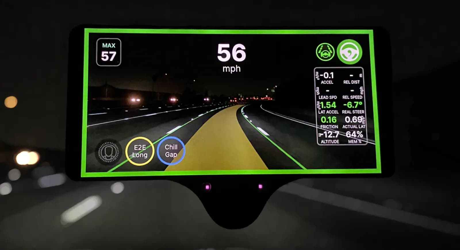 A comma three at night showing the sunnypilot driving screen with the speed and lane lines