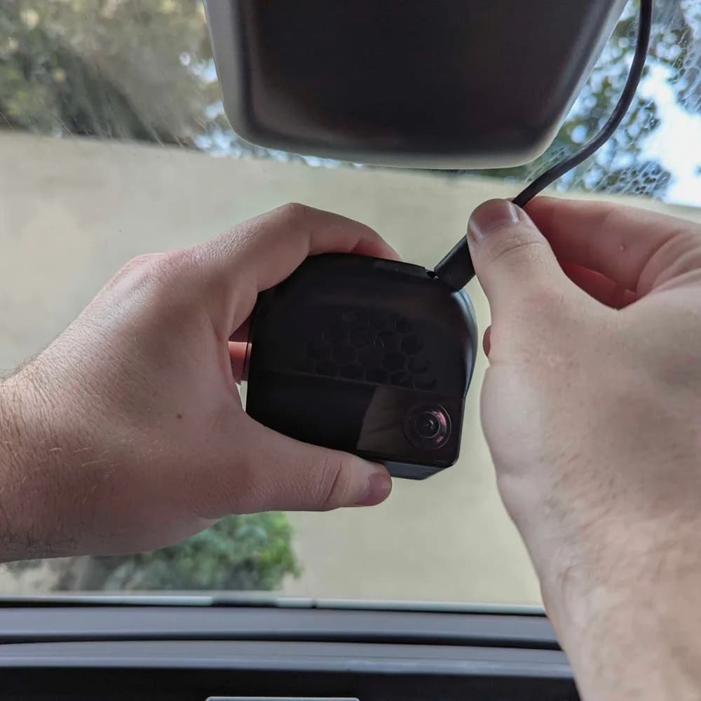 Connecting the cable to a comma four below a car’s rearview mirror
