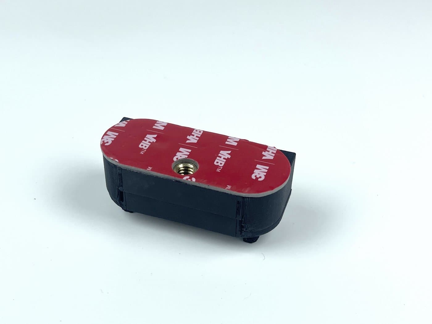 The windshield half of the BearTech Slidemount with its red tape pad
